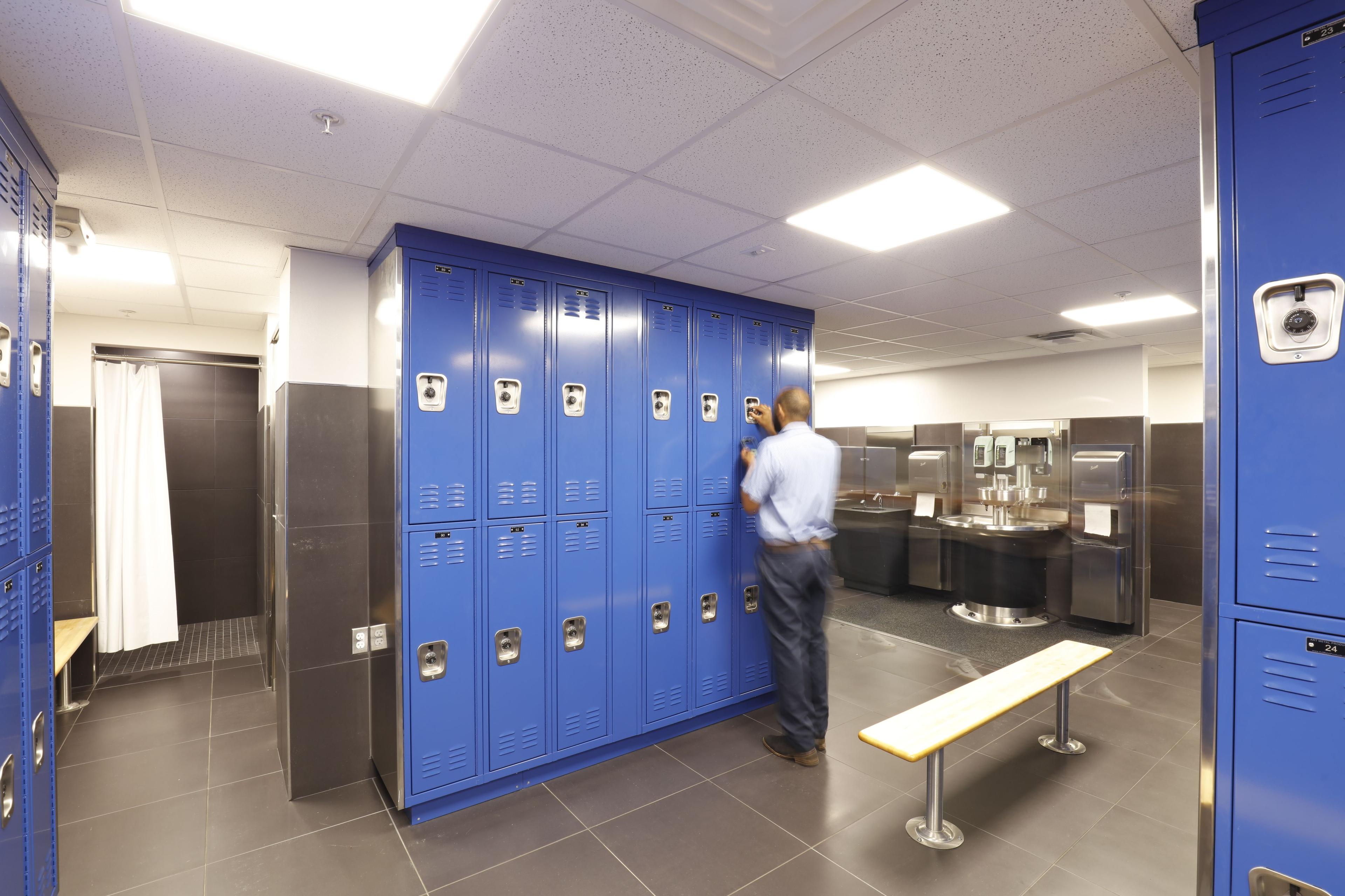 person in front of lockers in locker room