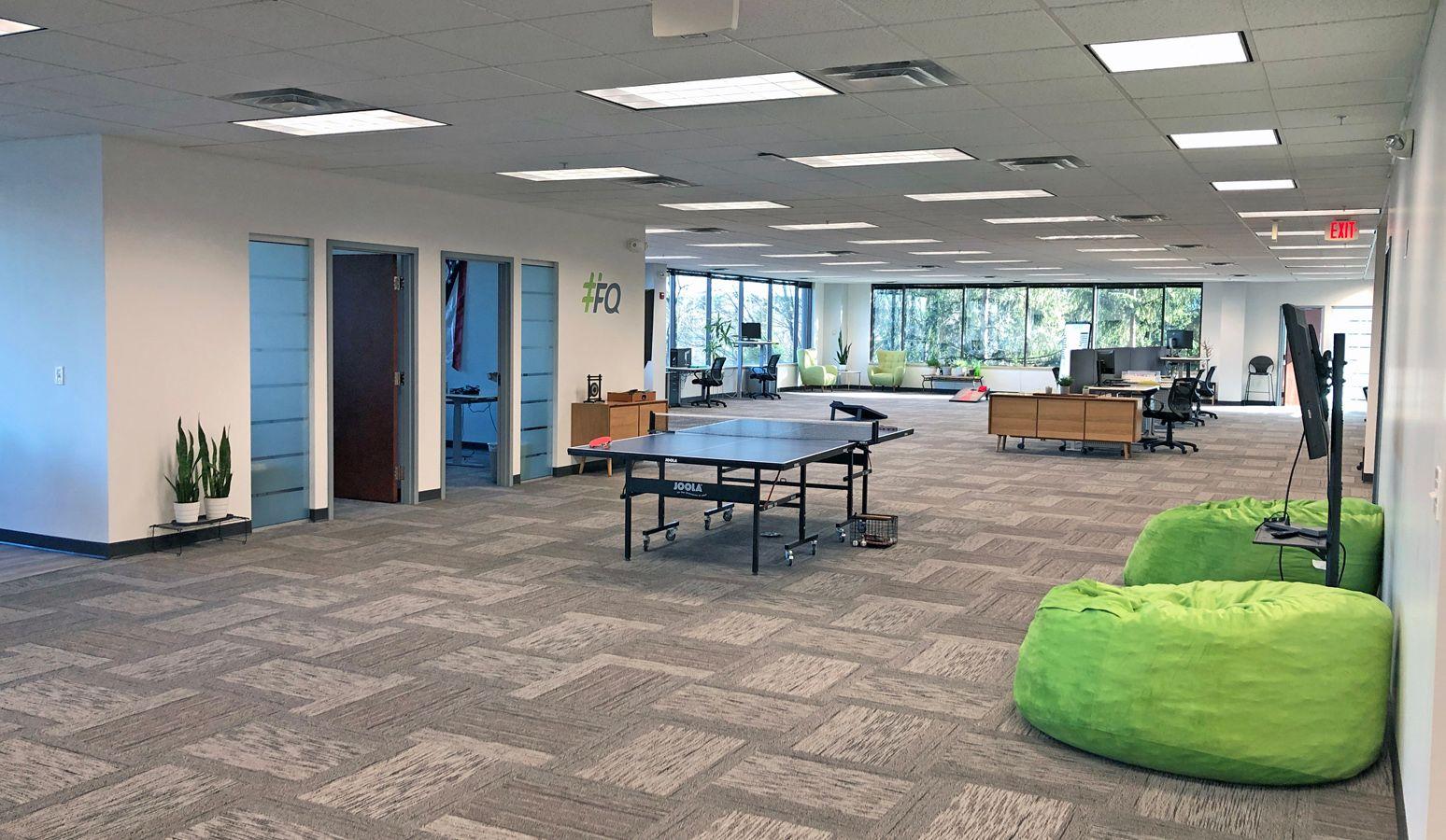 open office area with bean bags and pingpong tables