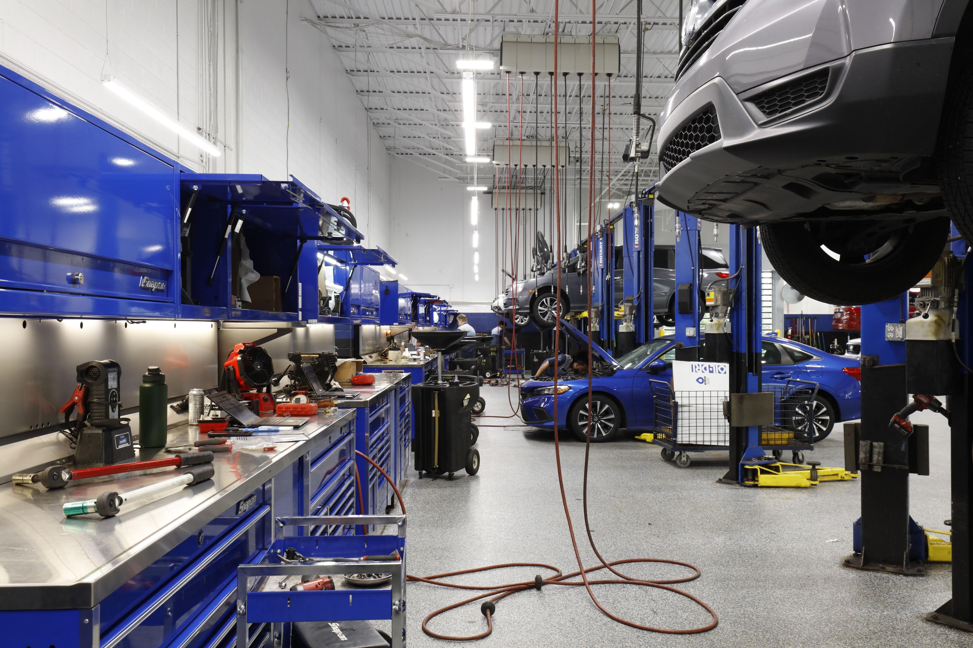 car mechanic set up with work benches and lifted cards