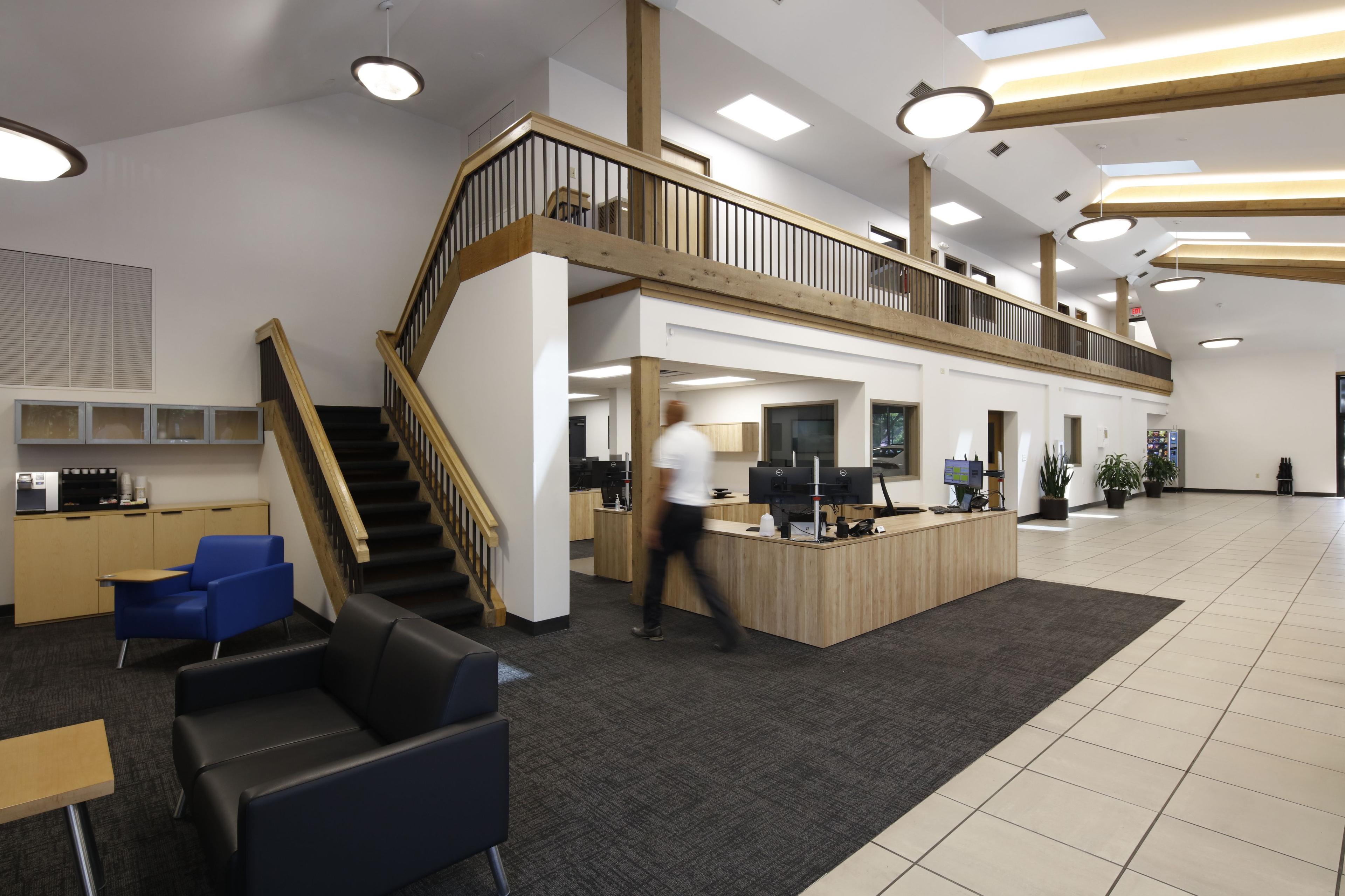 lobby with stairs, desks, and waiting area