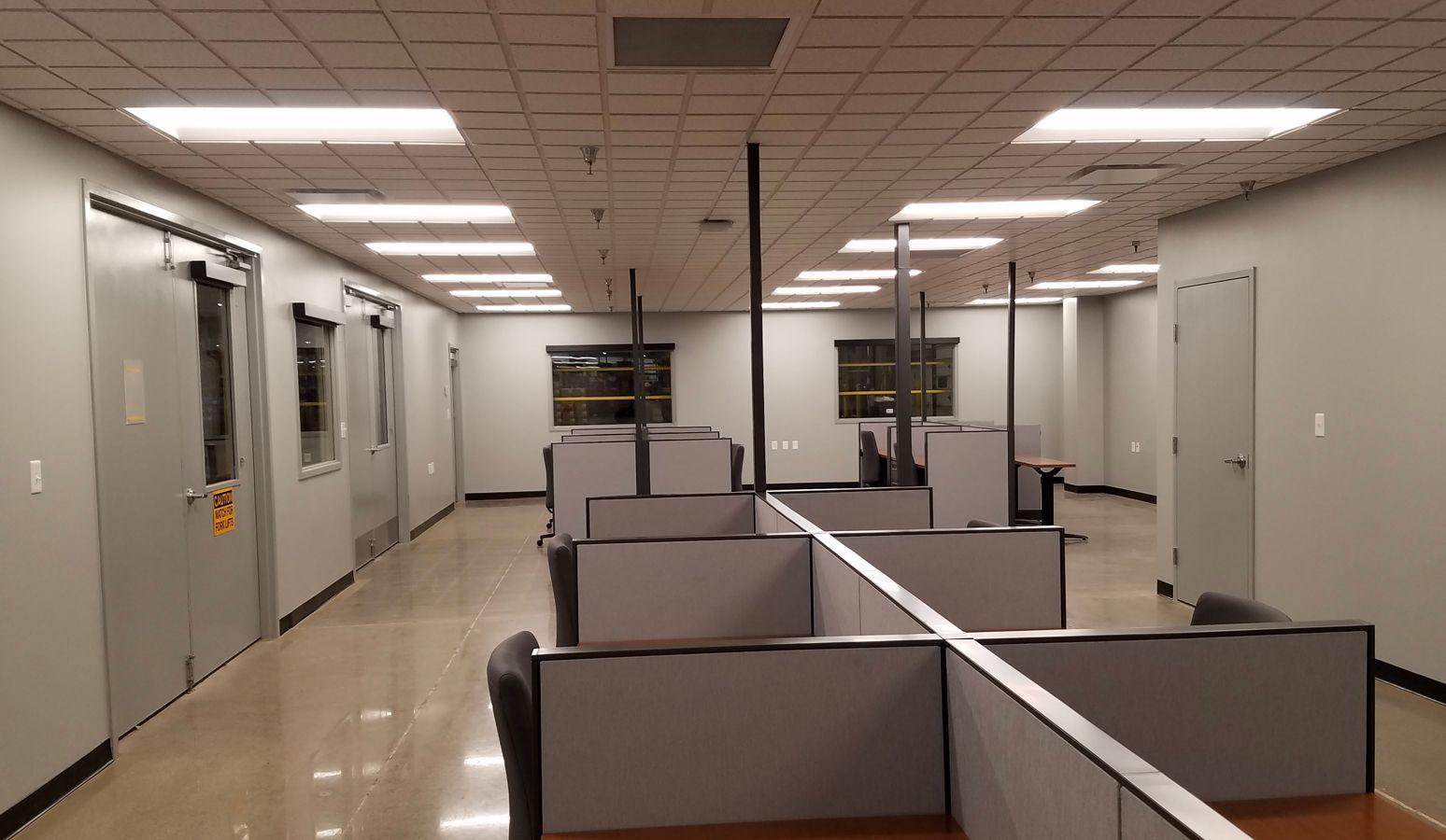 multiple desks in a cubicle