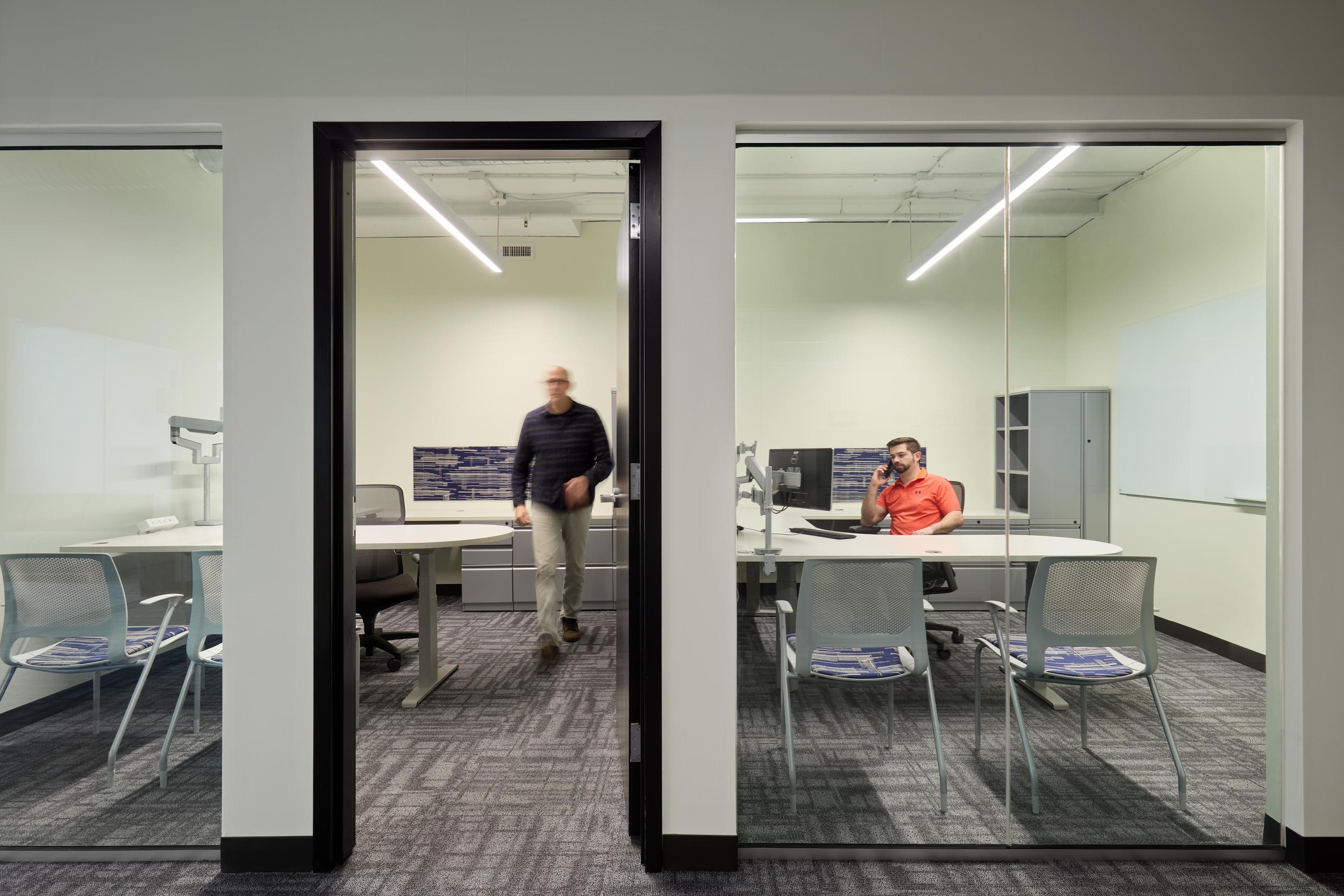 two people in a office with glass walls