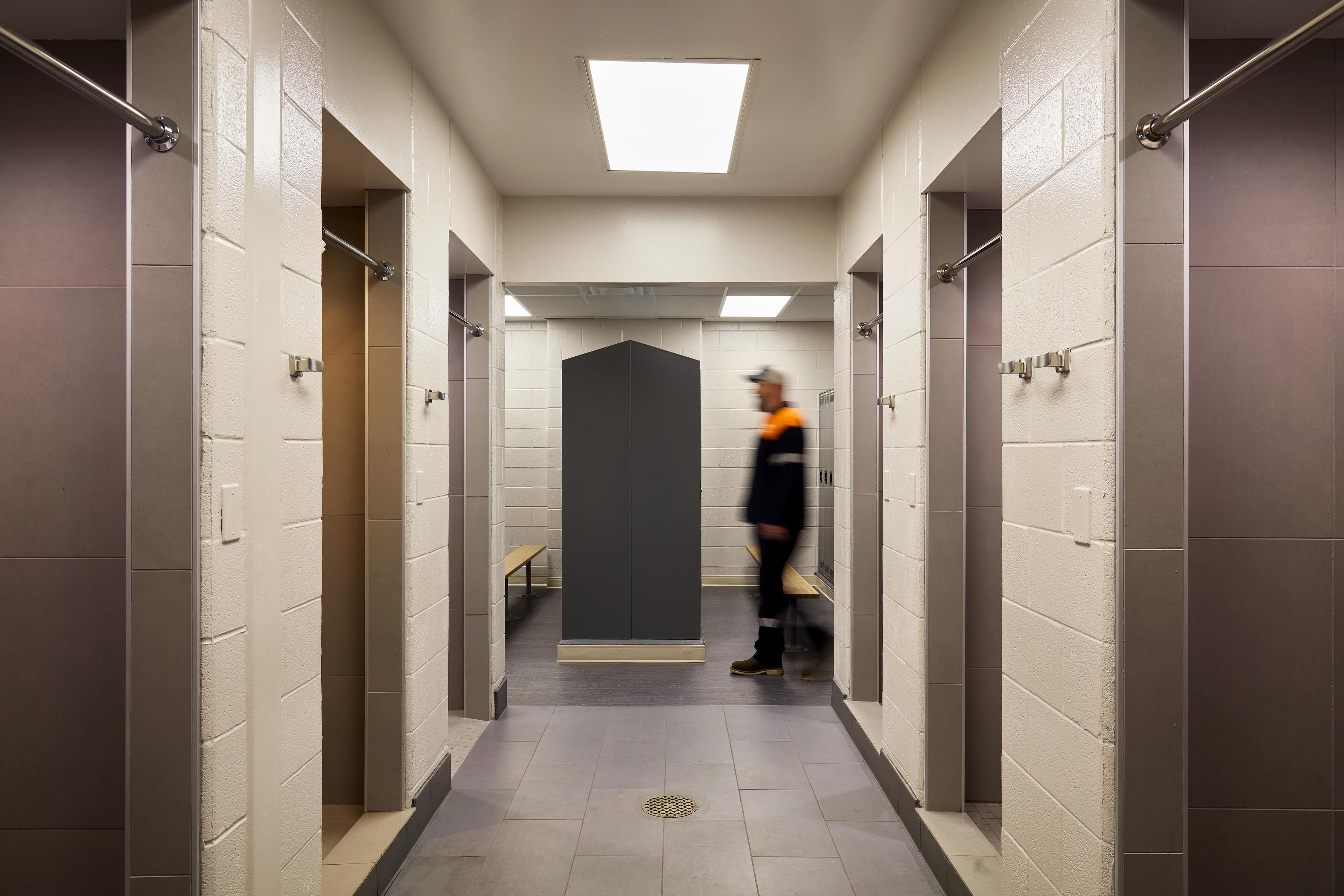 Locker room with shower stalls on either side