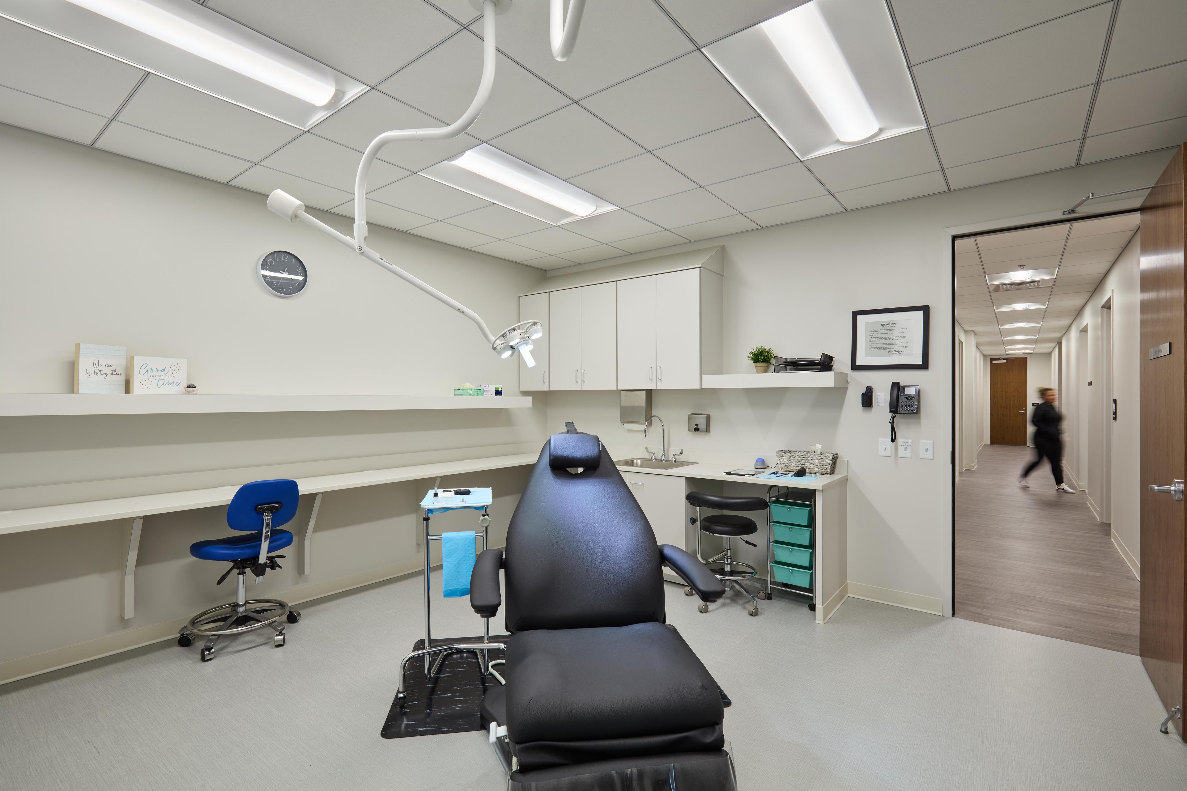 Medical facility room with a patient chair in the middle