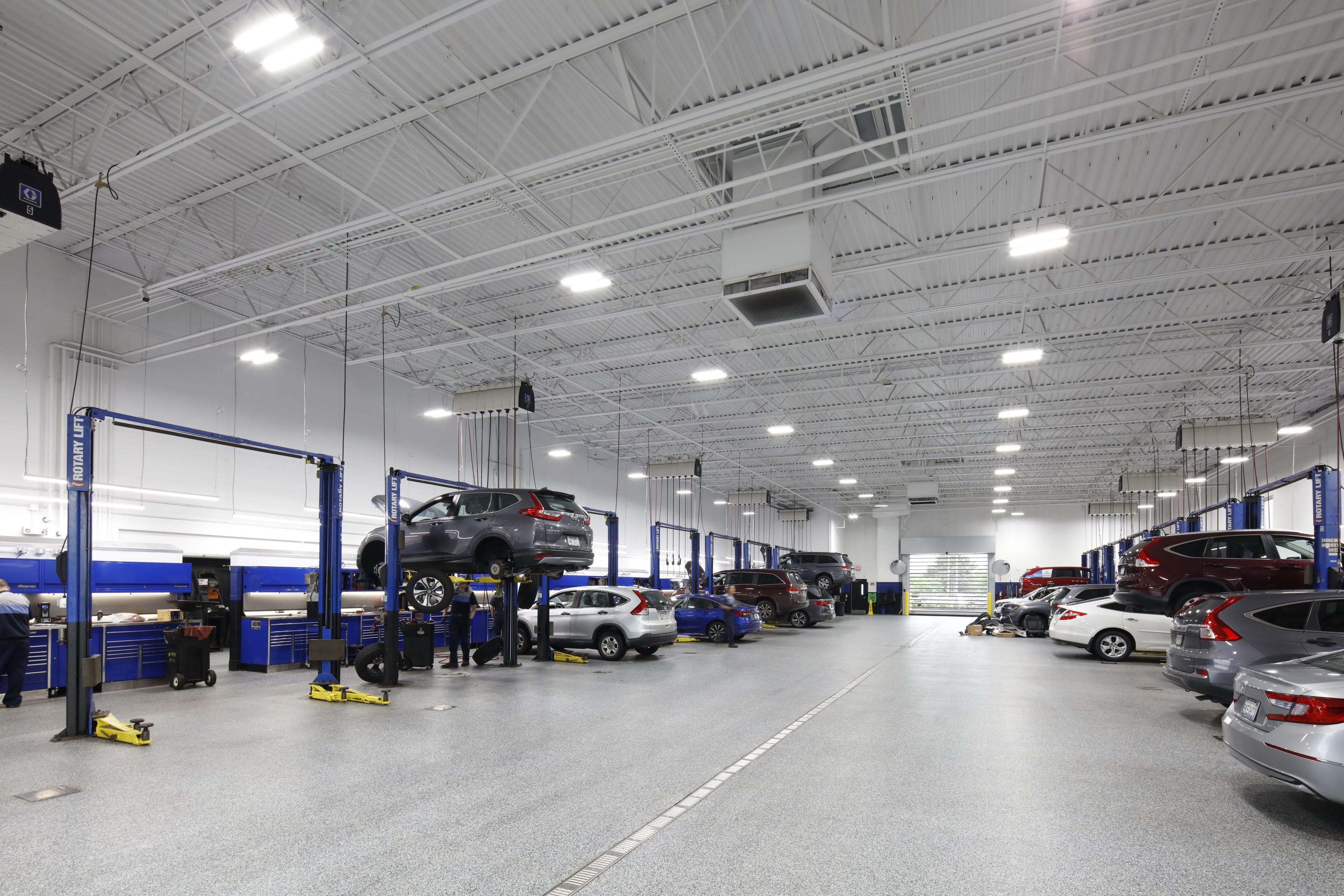 lifted cars in large mechanics room